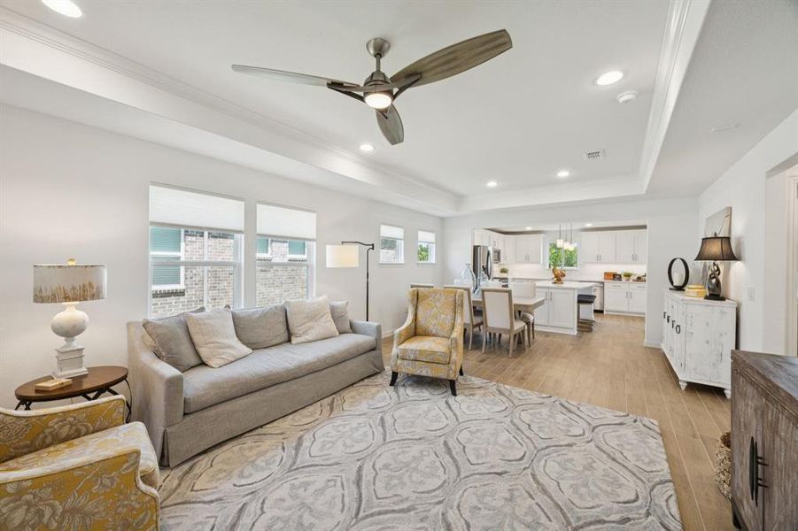 Perfection! This is a wonderful open floorplan that is full of light. The tray ceiling adds to the spacious feel of the home. The flooring is wood-look tile giving ease of maintenance. Other features of the room include ceiling fan and recessed lighting.