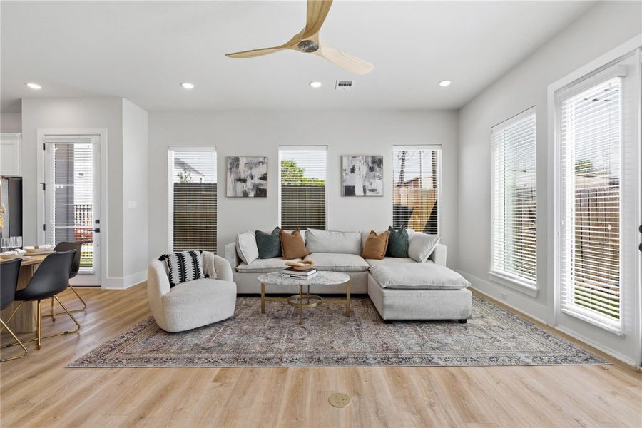 Framed by evenly spaced windows, the living area showcases balanced design and consistent natural light throughout. Framed by evenly spaced windows, the living area showcases balanced design and consistent natural light throughout.