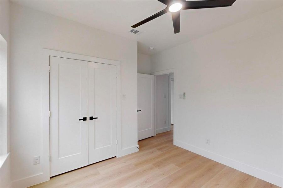 Unfurnished bedroom featuring light wood-style flooring, a closet, and ceiling fan Unfurnished bedroom featuring light wood-style flooring, a closet, and ceiling fan
