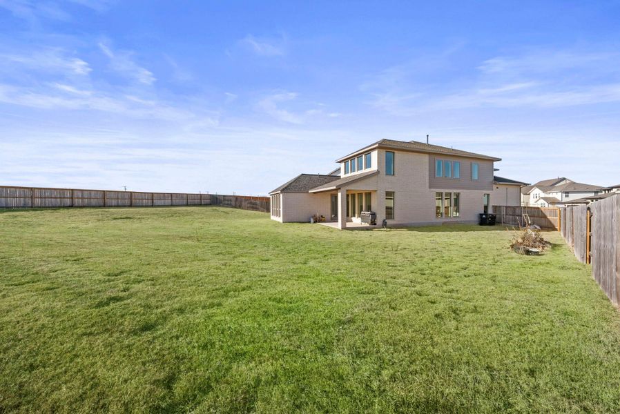 Back of property with a patio and a fenced backyard