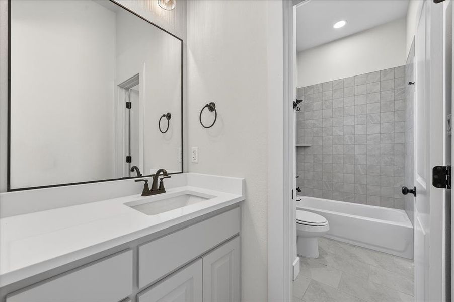 Bathroom featuring vanity, washtub / shower combination, and recessed lighting