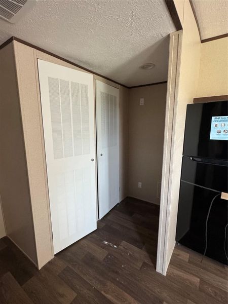 Laminate flooring pairs with utility closets in this functional hallway alcove.