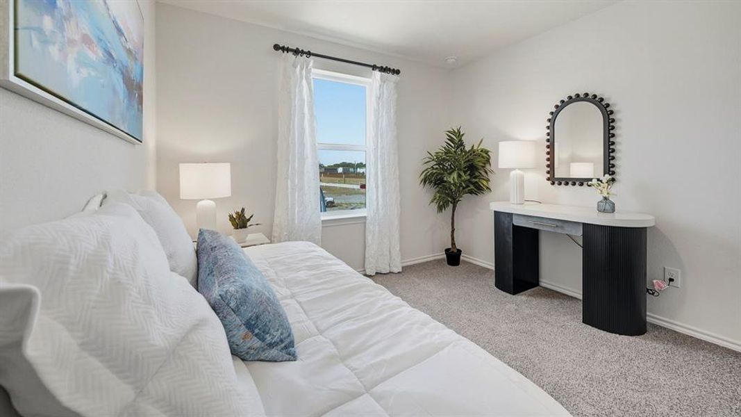 Bedroom featuring light colored carpet and baseboards Bedroom featuring light colored carpet and baseboards