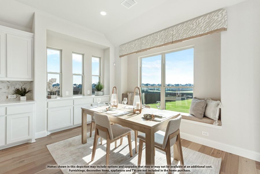 Bright dining area with wood table, built-in window bench seat, and large windows overlooking backyard Bright dining area with wood table, built-in window bench seat, and large windows overlooking backyard
