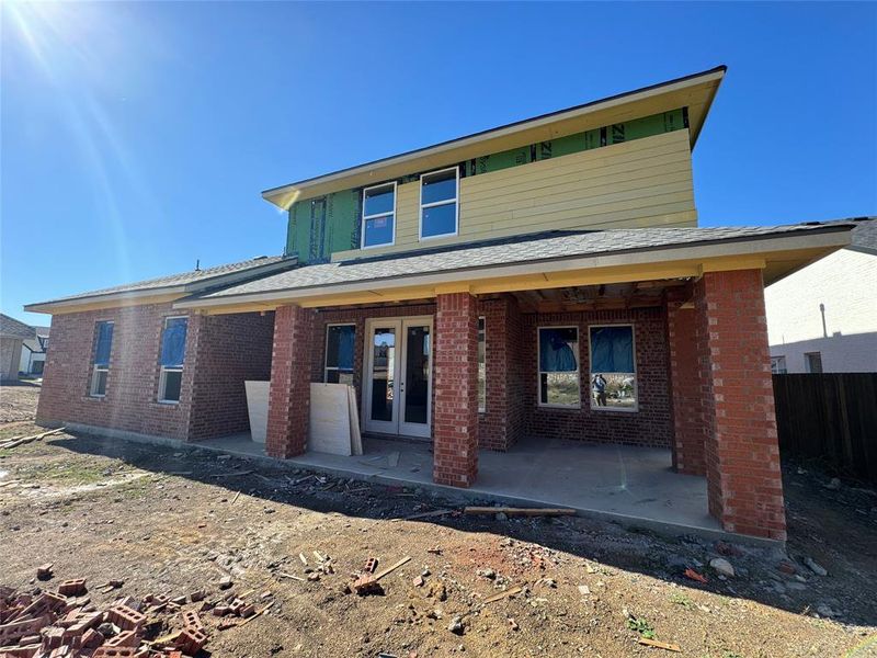 View of front of property with french doors and a patio