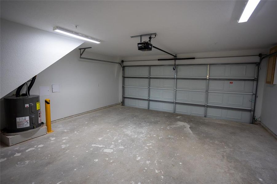 Garage with electric water heater and a garage door opener