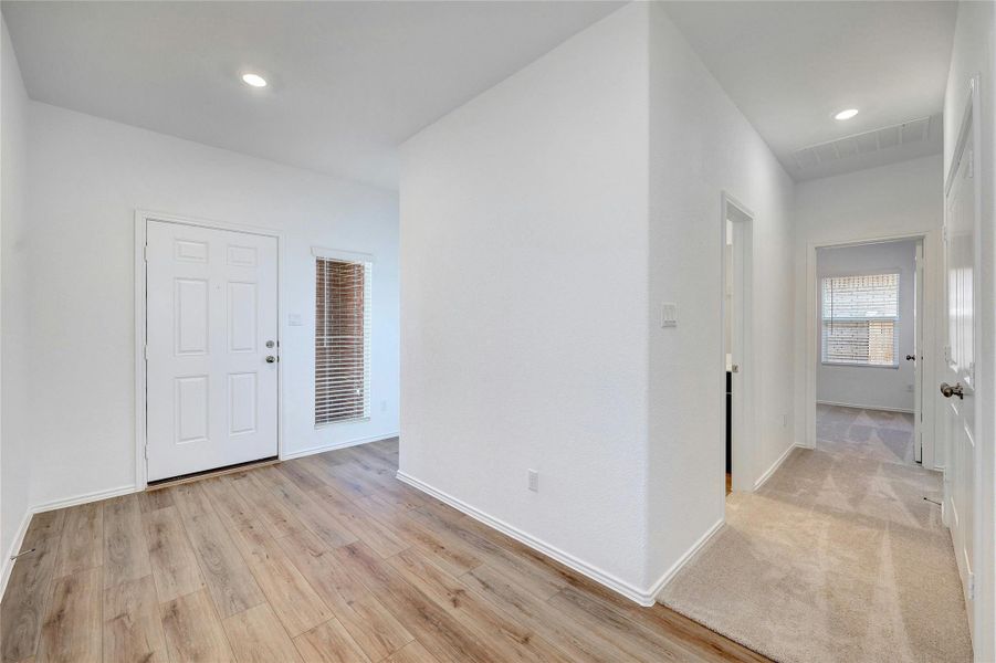 Foyer with recessed lighting and light wood finished floors