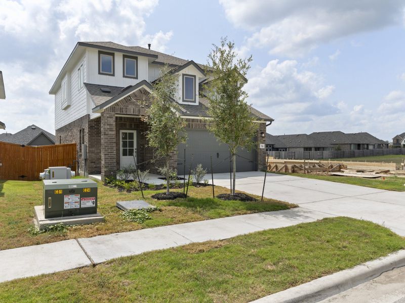 Front exterior of a new home in Crosswinds, Kyle, TX, highlighting curb appeal (Image 24).