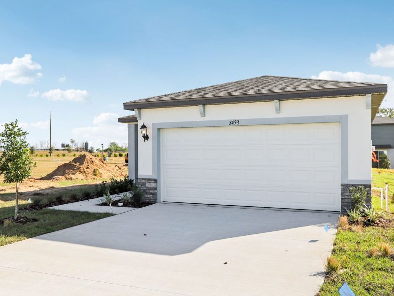Front exterior of a new home in Benton Hills - Premier Series, Brooksville, FL, highlighting curb appeal (Image 2). Front exterior of a new home in Benton Hills - Premier Series, Brooksville, FL, highlighting curb appeal (Image 2).