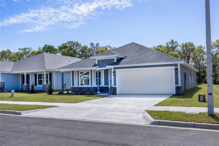 Front exterior of a new home in Kirkland Farms, Alachua, FL, highlighting curb appeal (Image 18).