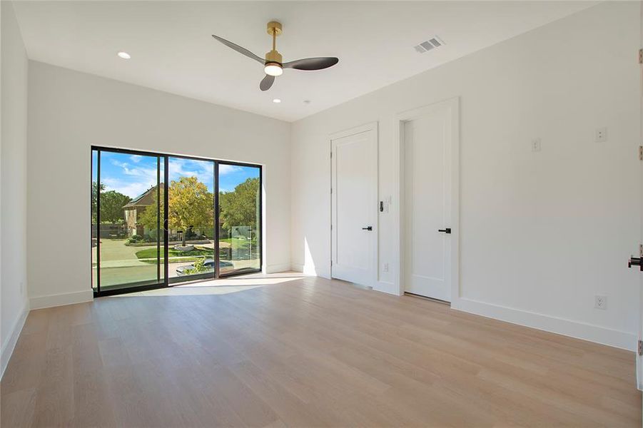 Empty room with light hardwood / wood-style floors and ceiling fan