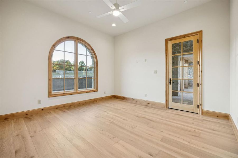 Unfurnished room with light wood-type flooring, a water view, a ceiling fan, and recessed lighting