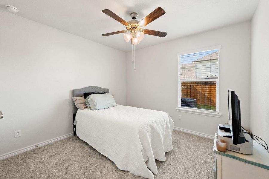 Bedroom featuring light carpet and a ceiling fan