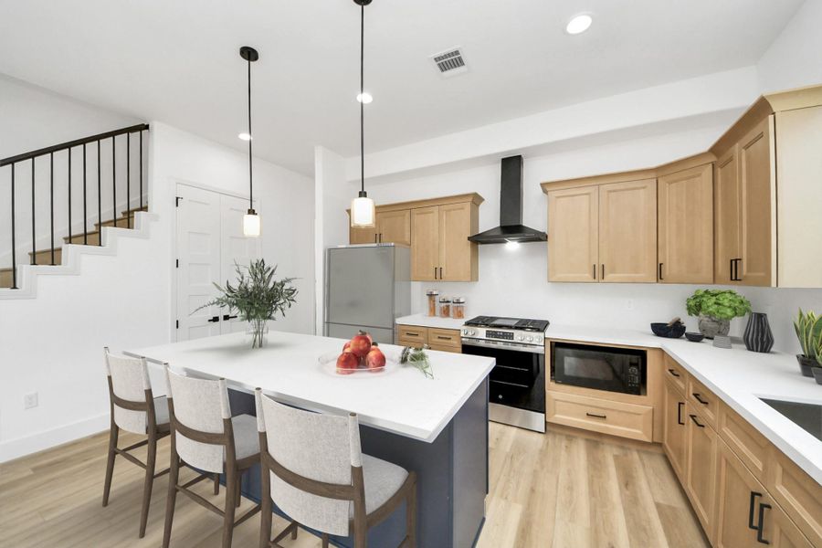 Spacious kitchen offers stainless steel appliances (stove, dishwasher, microwave only) & quartz countertops.