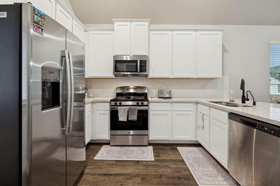 The kitchen is a chef's dream with modern appliances, ample counter space, and a large island that doubles as a breakfast bar.