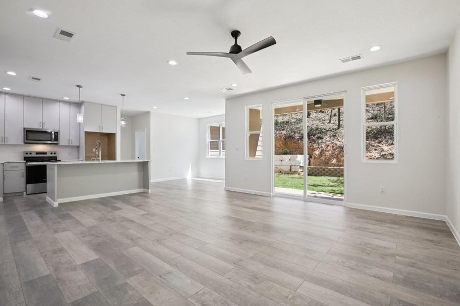 Unfurnished living room with ceiling fan, recessed lighting, and  light wood-type laminate flooring