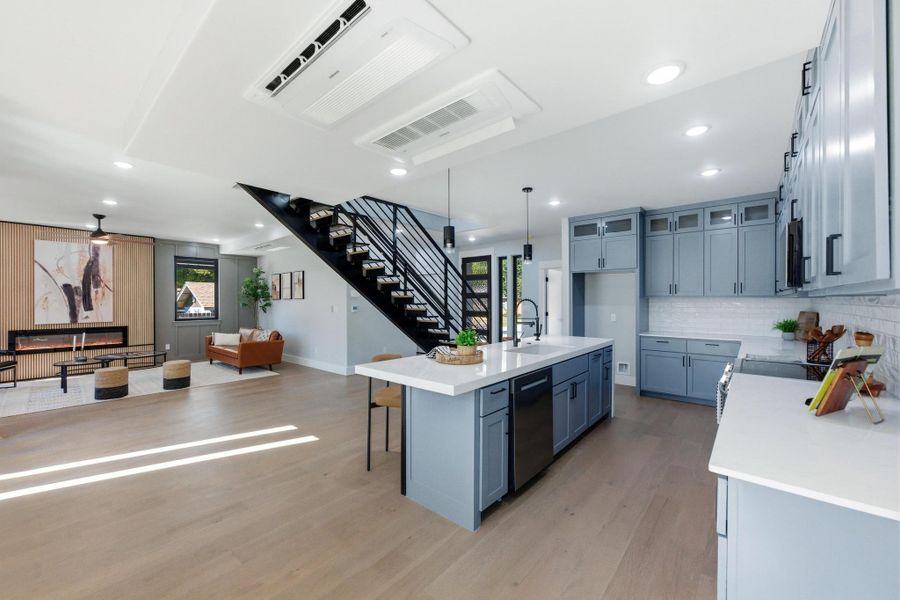 Kitchen featuring a breakfast bar area, plenty of natural light, backsplash, a center island with sink, and recessed lighting Kitchen featuring a breakfast bar area, plenty of natural light, backsplash, a center island with sink, and recessed lighting