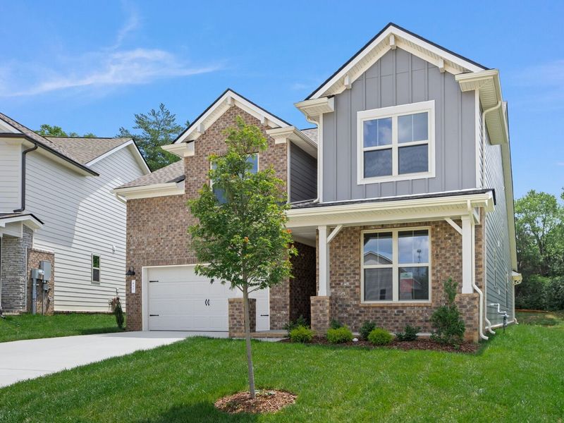 Front exterior of a new home in Woods Crossing, Gallatin, TN, highlighting curb appeal (Image 29).
