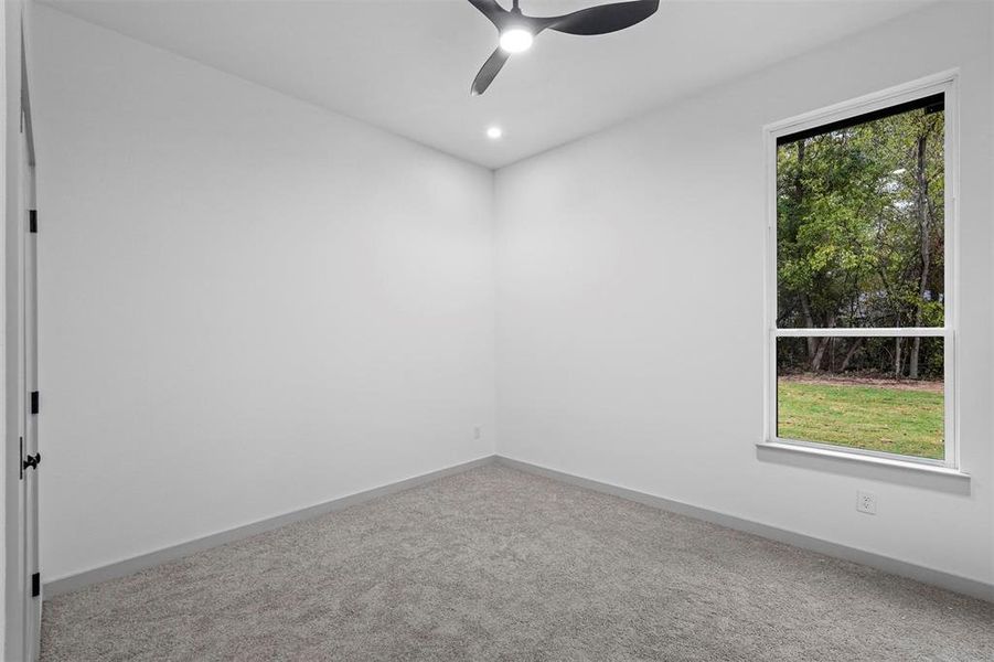 Empty room with carpet flooring and ceiling fan