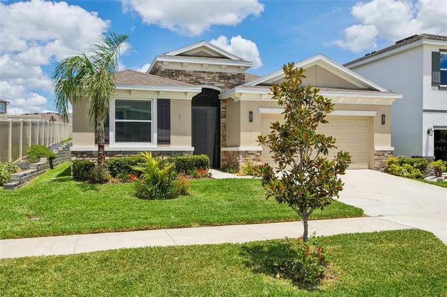 Front exterior of a new home in Epperson, Wesley Chapel, FL, highlighting curb appeal (Image 27). Front exterior of a new home in Epperson, Wesley Chapel, FL, highlighting curb appeal (Image 27).