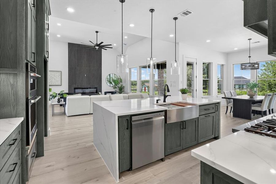 Kitchen island with waterfall countertop and undermount stainless steel farmhouse sink