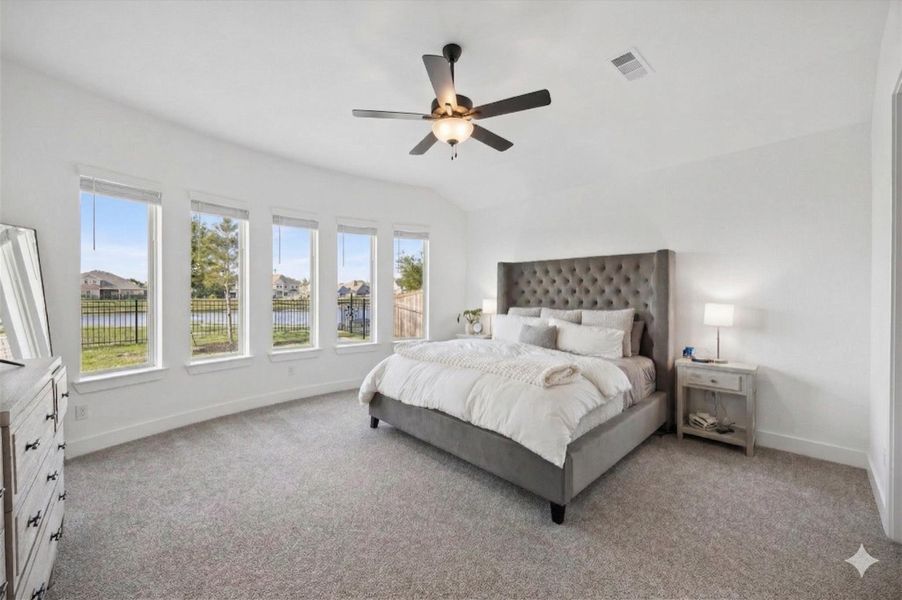 Spacious primary retreat featuring a beautiful bay window that fills the room with natural light. This peaceful suite is complete with upgraded carpeting, a ceiling fan, and a neutral palette, offering plenty of space for oversized furniture. Spacious primary retreat featuring a beautiful bay window that fills the room with natural light. This peaceful suite is complete with upgraded carpeting, a ceiling fan, and a neutral palette, offering plenty of space for oversized furniture.