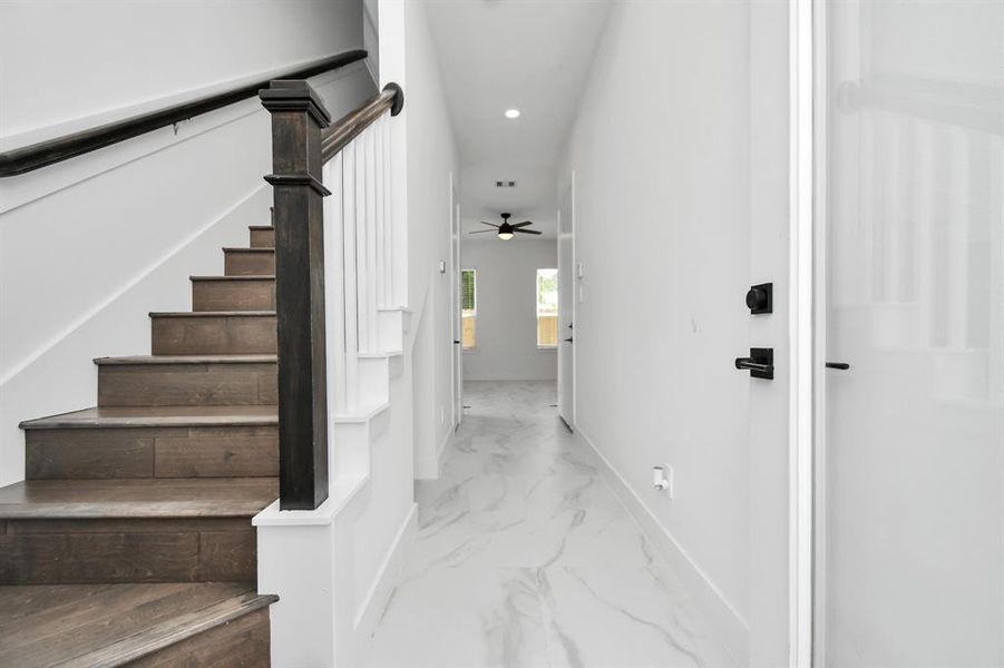 Enjoy the elegance in contrast in this elegant entryway with beautiful tiled flooring leading to first-floor living and the engineered hardwood stairway leading to the second floor.