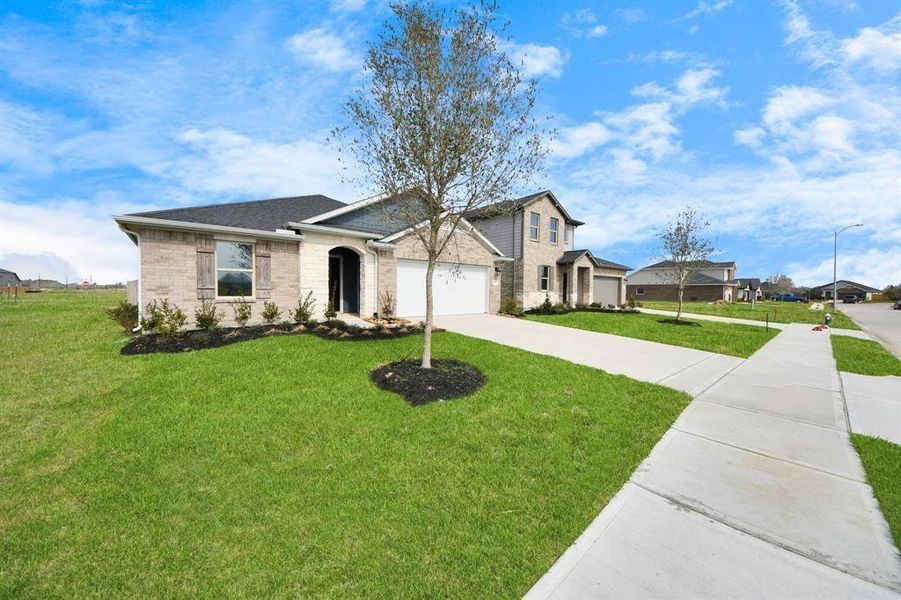 Front exterior of a new home in Sweetgrass Village, Crosby, TX, highlighting curb appeal (Image 26).