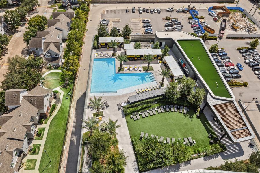 An elevated view of the expansive pool area featuring cabanas and tanning chairs. An elevated view of the expansive pool area featuring cabanas and tanning chairs.