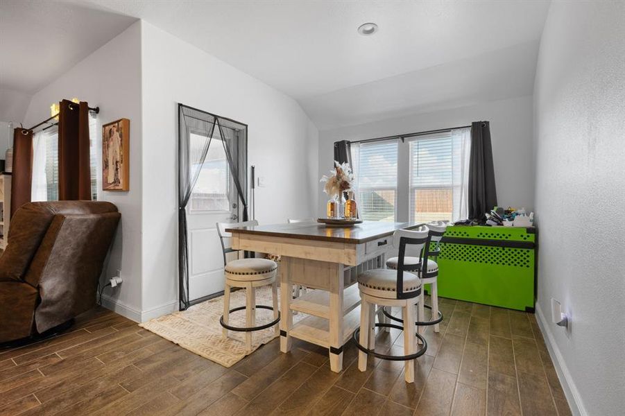 Dining room featuring lofted ceiling and wood tiled floors Dining room featuring lofted ceiling and wood tiled floors