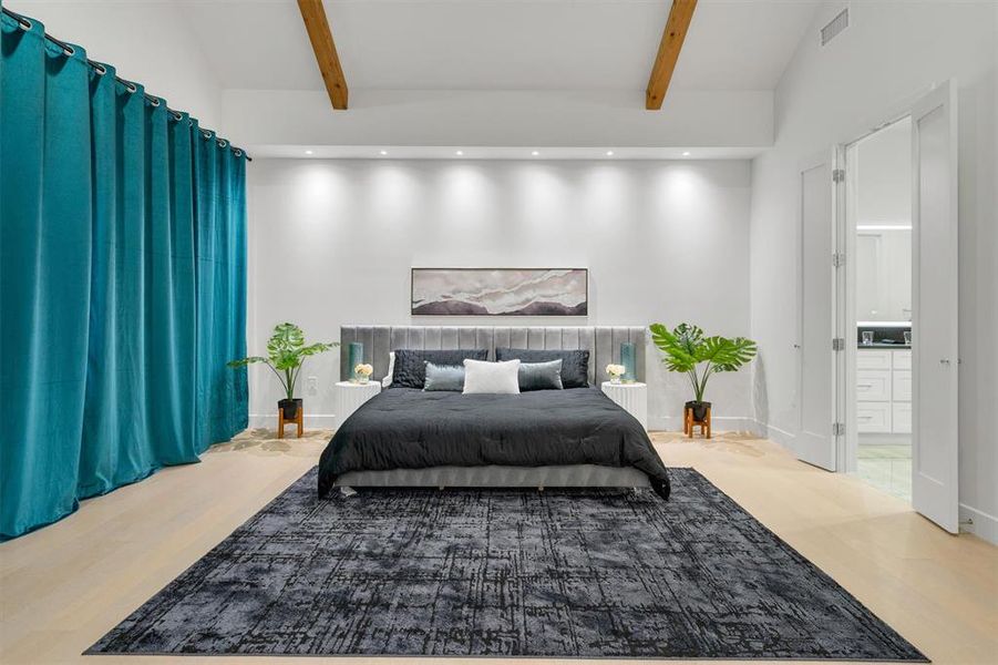 Bedroom featuring recessed lighting, lofted ceiling, connected bathroom, and light wood-style flooring Bedroom featuring recessed lighting, lofted ceiling, connected bathroom, and light wood-style flooring