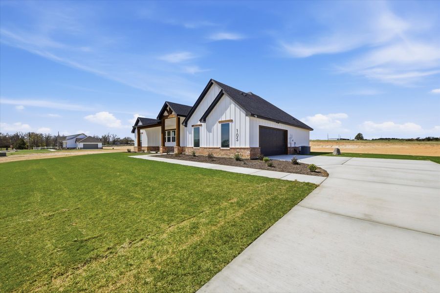 Front exterior of a new home in Zion Valley, Poolville, TX, highlighting curb appeal (Image 23).