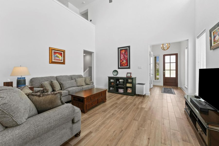 The impressive two-story great room, a hallmark of the Brookfield 'Rutgers' floor plan, is a grand and spacious gathering area. High ceilings and large windows create a bright and airy atmosphere.