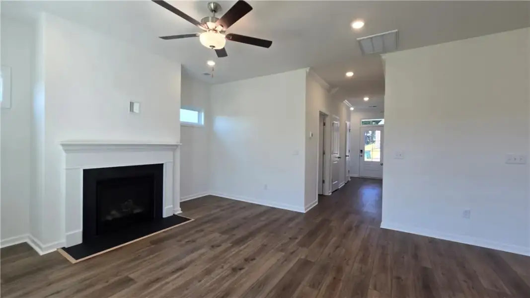 A classic fireplace anchors the open-plan main lev