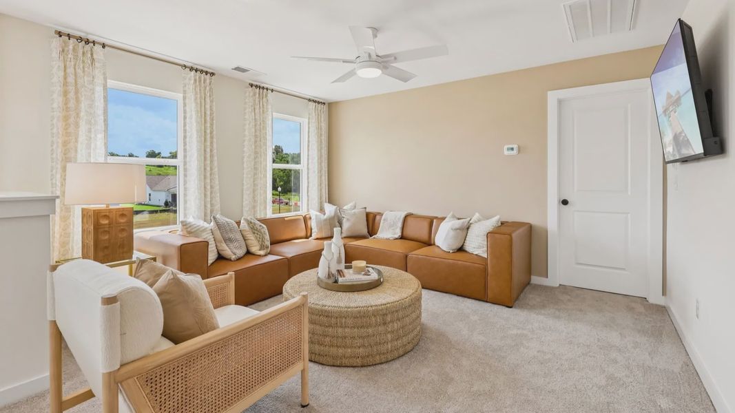 Loft area with carpet and natural lighting from windows
