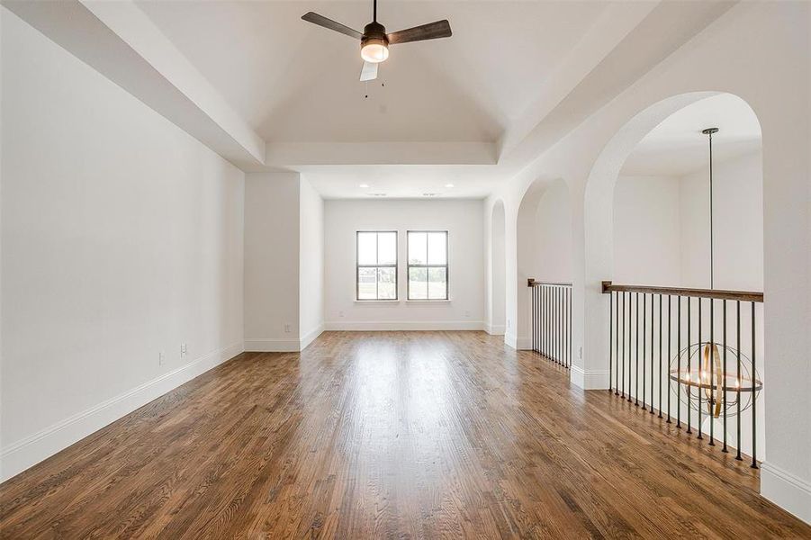 Unfurnished room featuring ceiling fan and dark hardwood / wood-style floors