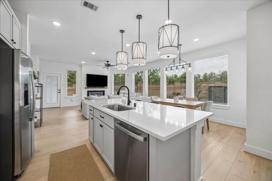 This thoughtfully designed layout features recessed lighting and a full wall of windows overlooking the backyard, filling the space with natural light.