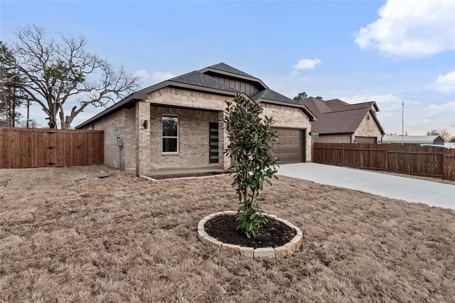 View of front of home featuring a garage and a front lawn