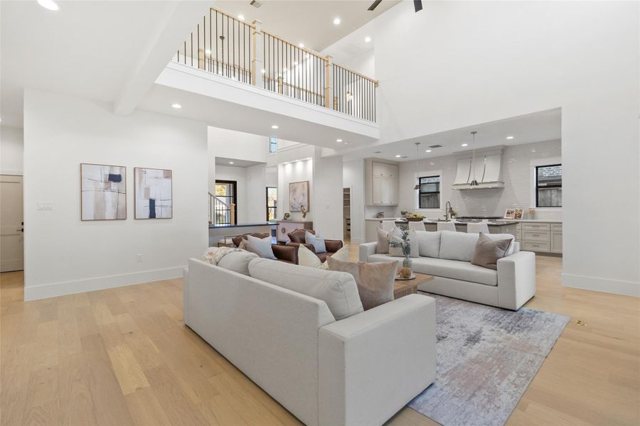 From this angle, your dramatic floor-to-ceiling brick fireplace becomes the focal point, anchoring the living space while framing sightlines straight into the kitchen. Whether you’re hosting friends or enjoying a quiet night in, everything stays connected without sacrificing visual impact.