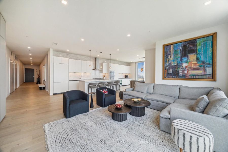 Gallery walls along the entry and spacious living room opens to the kitchen.