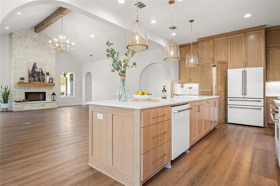Kitchen with arched walkways, beam ceiling, open floor plan, light wood-style floors, and white appliances