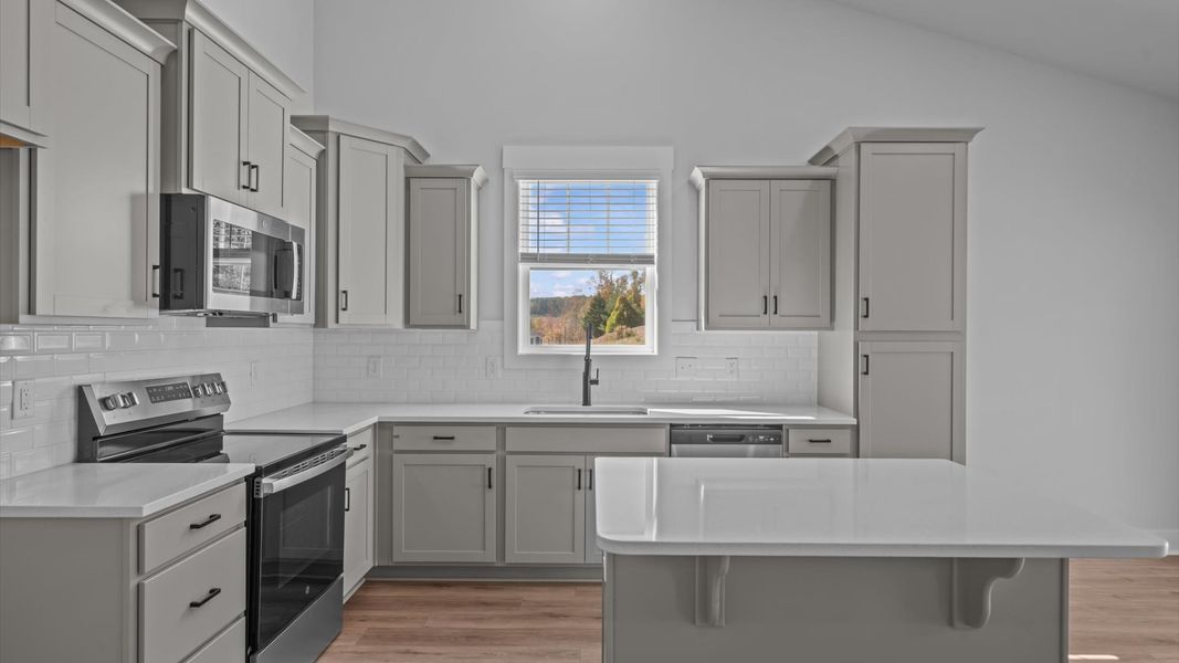 Elegant kitchen featuring a functional island and clean, current styling throughout
