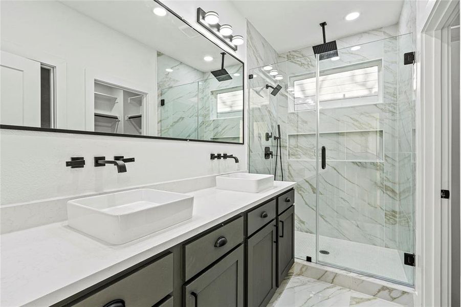 Full bathroom with light marble finish flooring, double vanity, a marble finish shower, recessed lighting, and a spacious closet