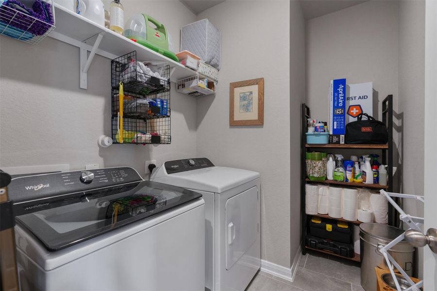 Dedicated laundry area featuring a top-load washing machine and a front-load dryer Dedicated laundry area featuring a top-load washing machine and a front-load dryer