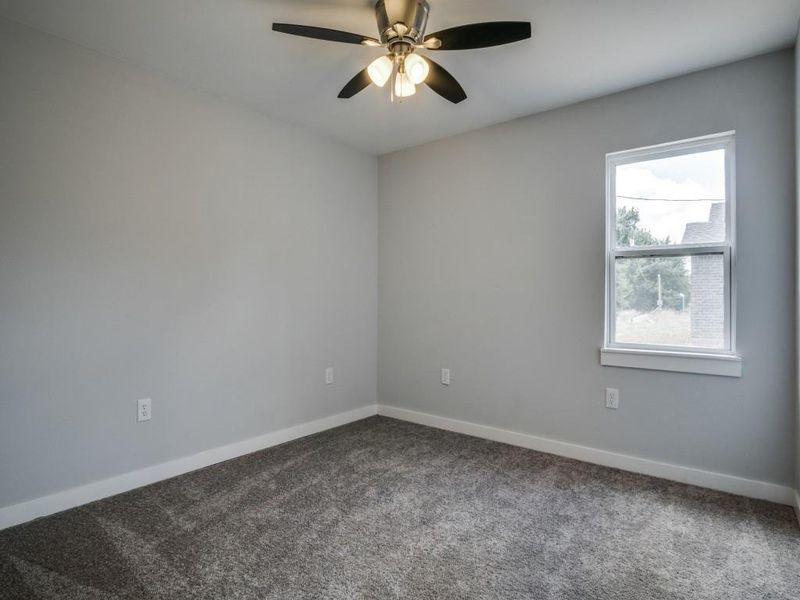 Unfurnished room with ceiling fan and carpet Unfurnished room with ceiling fan and carpet