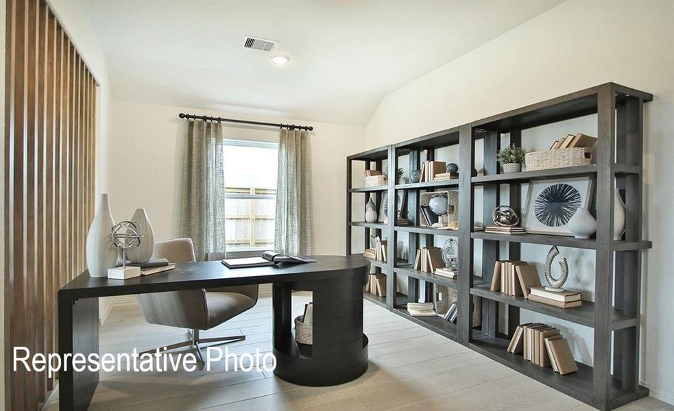 Office area featuring light wood-type flooring and lofted ceiling