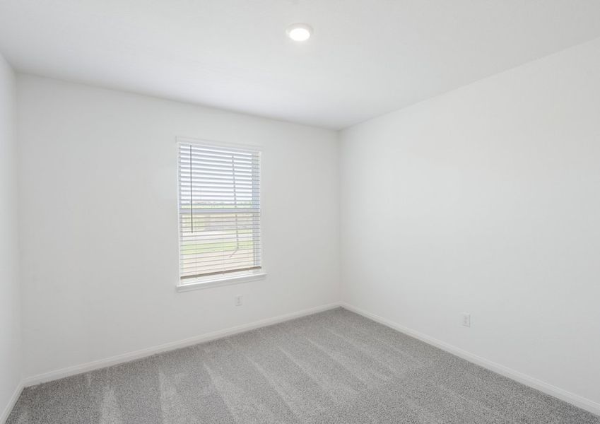 Secondary bedroom with lush carpet flooring
