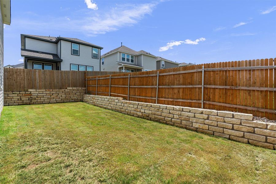 Fenced backyard featuring a residential view