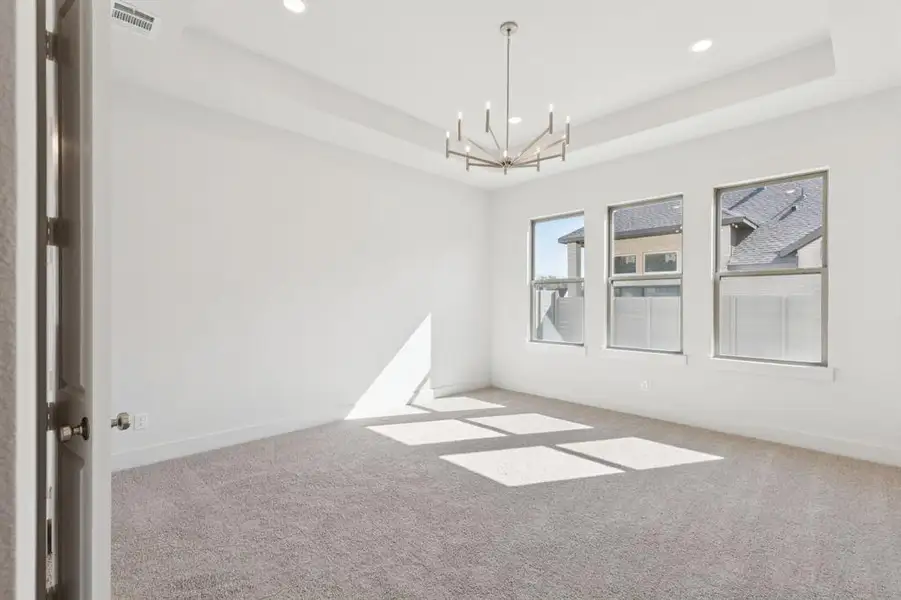 This dreamy owner's suite is located at the rear of the home for additional privacy.