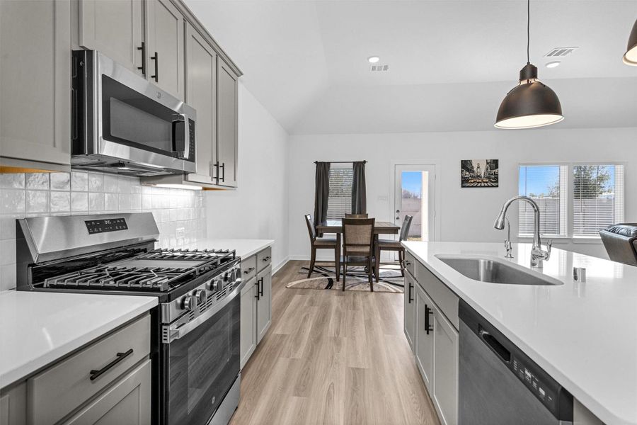 This additional view of the kitchen highlights its open layout and seamless connection to the dinning area.